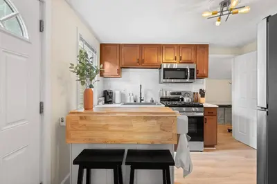 a kitchen with a sink and a stove top oven at Charming Home in Cleveland 3215 in Ohio City