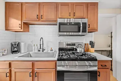 a kitchen with a stove and a microwave at Charming Home in Cleveland 3215 in Ohio City