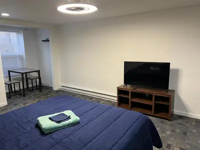 a bedroom with a bed and a flat screen tv at The Haven in Toledo
