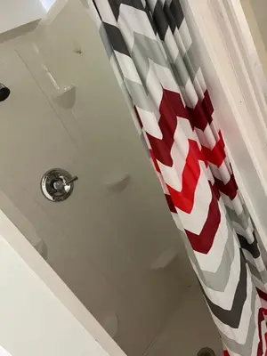 a red and white shower curtain in a bathroom at The Haven in Toledo