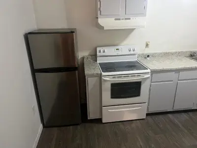 a kitchen with a stove and a refrigerator at The Haven in Toledo