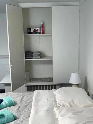 a bedroom with a bed and a lamp and shelves at The Haven in Toledo