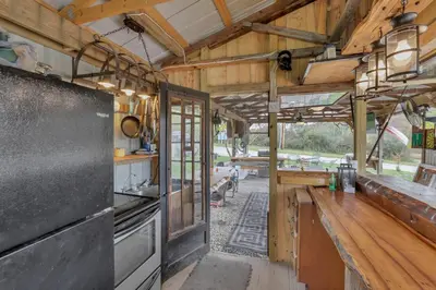 a kitchen with wooden walls and a counter in a house at Cozy Cabin in New Lexington