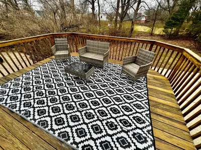 two chairs and a table on a wooden deck at Private Bedroom Suite 4 Cape Cod Cutie 10 Min to Downtown in Bromley