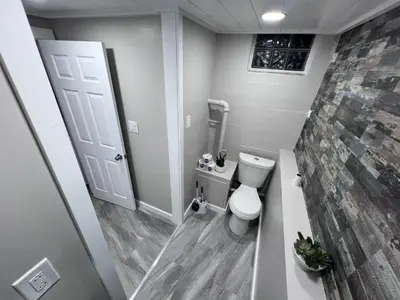 a small bathroom with a toilet and a window at Private Bedroom Suite 4 Cape Cod Cutie 10 Min to Downtown in Bromley