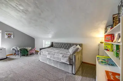 a bedroom with a bed and a table in it at Grandma Kellys Southeast Indiana Farmhouse! in Cedar Grove
