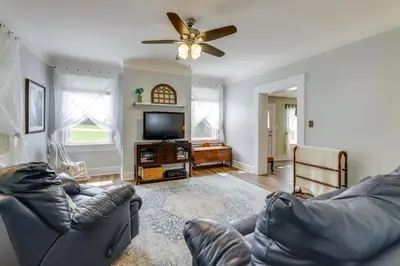 a living room with a couch and a flat screen tv at Grandma Kellys Southeast Indiana Farmhouse! in Cedar Grove