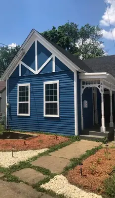 a blue house with a porch and a yard at Eco Friendly Home by Cincy w Office Space in Dayton