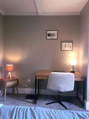 a bedroom with a desk with a chair and a lamp at Eco Friendly Home by Cincy w Office Space in Dayton