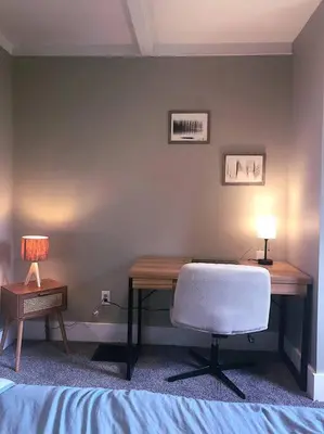 a bedroom with a desk with a chair and a lamp at Eco Friendly Home by Cincy w Office Space in Dayton