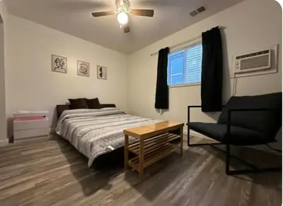 a bedroom with a bed and a chair and a ceiling fan at Nationwide Childrens Hospital close by in Columbus