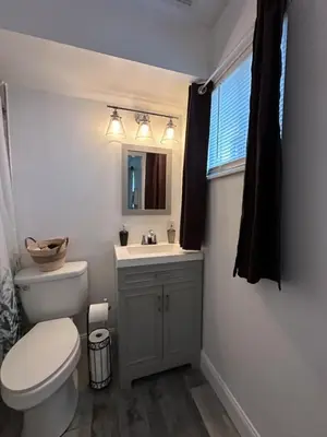 a bathroom with a toilet and a sink and a mirror at Nationwide Childrens Hospital close by in Columbus