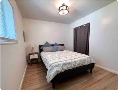 a bedroom with a bed with blue pillows at Nationwide Childrens Hospital close by in Columbus