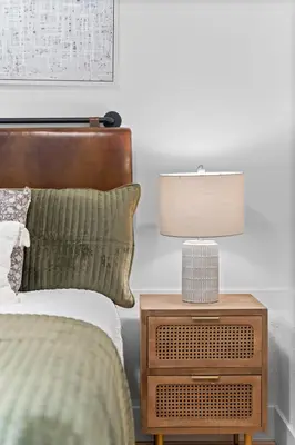 a bedroom with a bed and a nightstand with a lamp at Charming Home in Cleveland 3219 in Ohio City