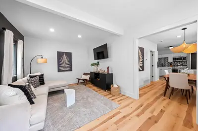 a white living room with a white couch and a table at Charming Home in Cleveland 3219 in Ohio City