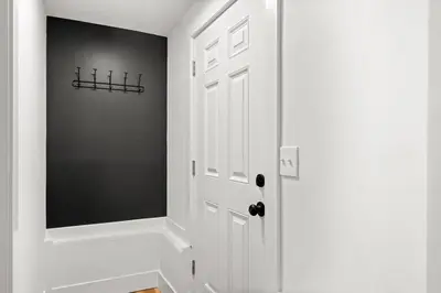 a hallway with a white door and a black wall at Charming Home in Cleveland 3219 in Ohio City