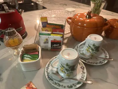 a table with two plates and a teapot at Irena Bed and Breakfast in Middleburg Heights