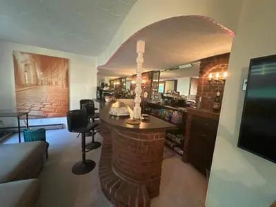 a living room with a fireplace in the middle of a room at Irena Bed and Breakfast in Middleburg Heights