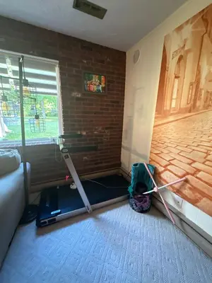 a room with a brick wall and a room with a mop at Irena Bed and Breakfast in Middleburg Heights