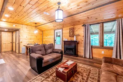 a living room with a couch and a table at Whispering Pines Retreat in Zuck
