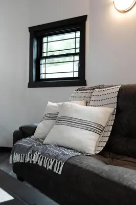 a couch in a living room with a window at Harvest Haven in Seaman