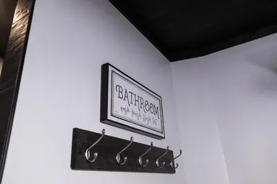 a wall with a picture on a wall with hangers at Harvest Haven in Seaman