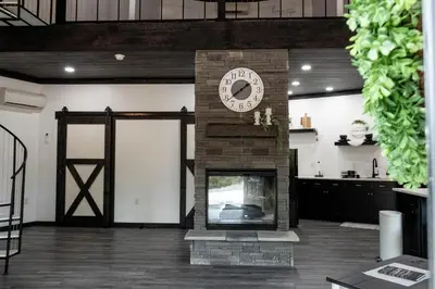 a room with a fireplace with a clock on it at Harvest Haven in Seaman
