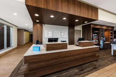 a lobby with a reception desk in a building at The Hilton Garden Inn in Grove City