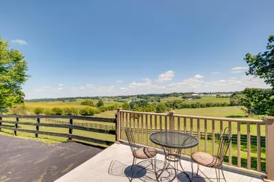 a patio with a table and two chairs and a fence at 4 Mi to German Village Studio with Hot Tub! in Millersburg