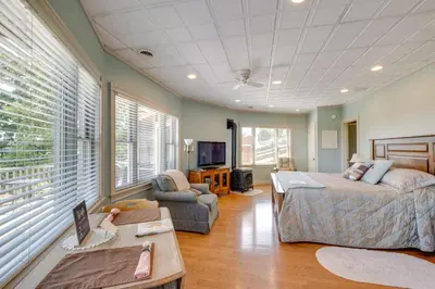 a bedroom with a bed and a couch and a tv at 4 Mi to German Village Studio with Hot Tub! in Millersburg