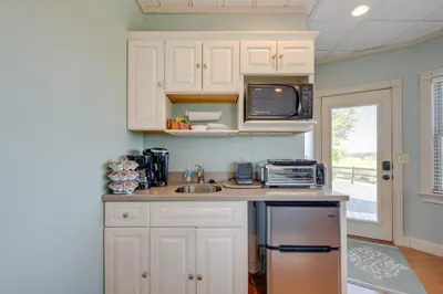 a kitchen with white cabinets and a sink and a microwave at 4 Mi to German Village Studio with Hot Tub! in Millersburg