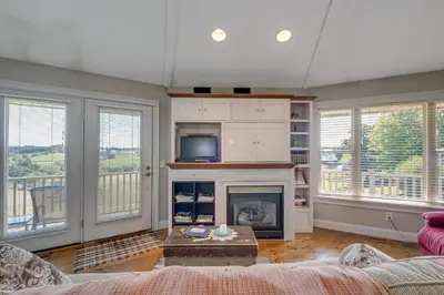 a living room with a fireplace and large windows at Panoramic Views Hillside Millersburg Studio in Millersburg