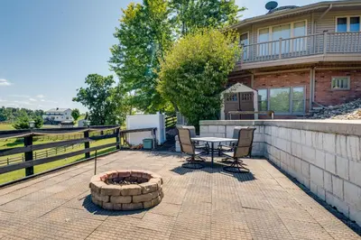 a patio with a table and chairs in front of a house at Panoramic Views Hillside Millersburg Studio in Millersburg