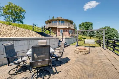 a patio with chairs and a fire pit in front of a building at Panoramic Views Hillside Millersburg Studio in Millersburg