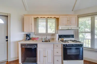 a kitchen with wooden cabinets and a stove top oven at Millersburg Getaway with Amish Country Views! in Millersburg