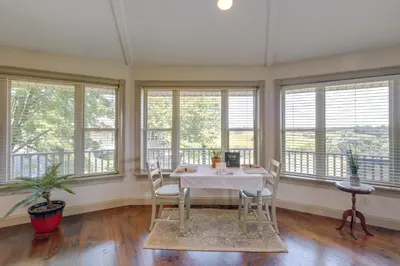a dining room with a table and chairs and windows at Millersburg Getaway with Amish Country Views! in Millersburg