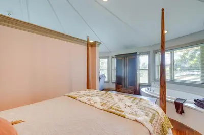 a bedroom with a bed and a bathroom with a window at Millersburg Getaway with Amish Country Views! in Millersburg