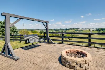 a fire pit on a patio with a bench at Holmes With a View Studio Millersburg Retreat! in Millersburg