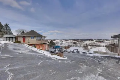 a house with a truck parked in the snow at Holmes With a View Studio Millersburg Retreat! in Millersburg