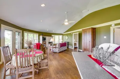 a living room with green walls and wooden floors at about 4 Mi to German Market Millersburg Retreat in Millersburg