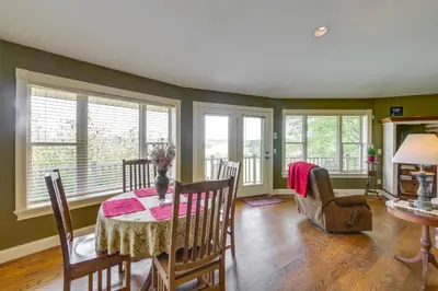 a dining room with a table and chairs and windows at about 4 Mi to German Market Millersburg Retreat in Millersburg