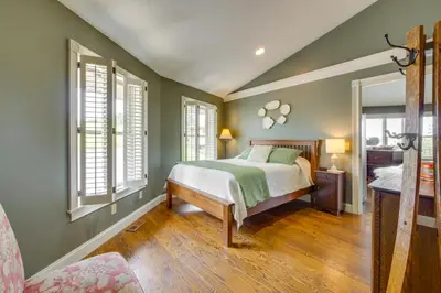 a bedroom with green walls and a bed and windows at about 4 Mi to German Market Millersburg Retreat in Millersburg