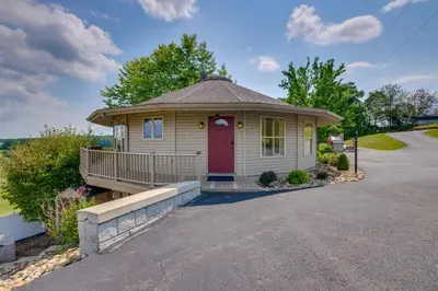 a small house with a red door on a street at about 4 Mi to German Market Millersburg Retreat in Millersburg