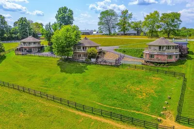 an aerial view of a large green field with houses at Amish Country Getaway with Pastoral Views! in Millersburg