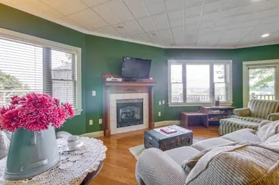 a living room with a couch and a fireplace at Amish Country Getaway with Pastoral Views! in Millersburg
