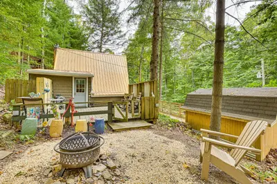 a backyard with a house and a fire pit at Carrollton Cabin with Patio and Fire Pit! in Carrollton