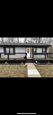 a large white house with a porch and a driveway at Very affordable Spacious private urban oasis in Cincinnati