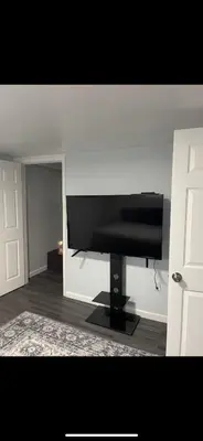 a living room with a black piano in a room at Very affordable Spacious private urban oasis in Cincinnati