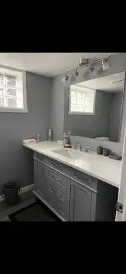 a bathroom with a sink and a mirror at Very affordable Spacious private urban oasis in Cincinnati