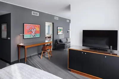 a bedroom with a bed and a flat screen tv at Le Meridien Columbus, The Joseph in Columbus